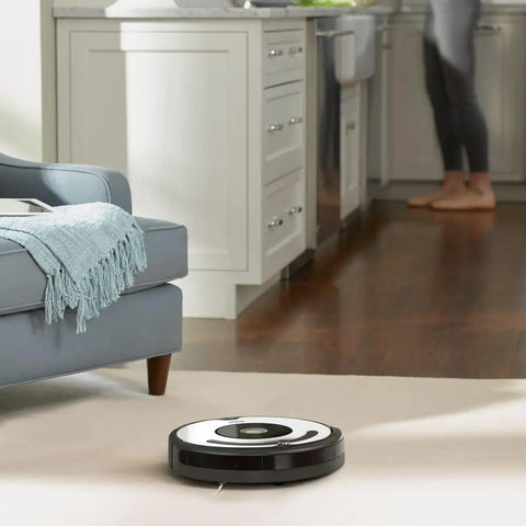 Roomba 600 Series vacuum cleaning a living room floor, showcasing Must Have Replacement Parts Kit For Roomba 600 Series Robots With AeroVac Filters Edge Sweeping Side Brush Bristle Brush Beater Brush And Round Cleaning Tool For 614 675 692 694 in action.