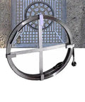 Premium Steel Drain Cleaning Rod For Nasty Household Gunk Badass Clog Ripper positioned above a drainage grate, showcasing its heavy-duty design.