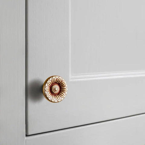 Six Pack Vintage Floral Cabinet Knobs Delivering A Straight Up Vintage Vibe With Weathered Nickel And Amber Red Gold Finishing Hand Styled For That Cool Country Touch On Kitchen Drawers Or Bathroom Cabinets. Antique gold floral knob on gray cabinet door.