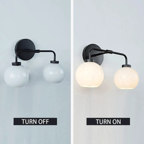 Double Glass Globe Wall Sconce, 17 Inch Sleek Modern Design In Matte Black, shown turned off and on with milk glass shade.