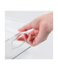 Hand holding clear plastic storage organizer bin set 4 pack for home organization, showcasing easy grip handle design.