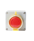 Front view of gray metal electrical control box with red circular emergency push button and yellow protective cover.