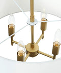 Interior view of 4 Light Modern Chandelier With White Linen Drum Shade In Antique Brass Finish showing four E12 bulbs