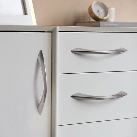 10 Pack Brushed Nickel Cabinet Pulls 5 Inch Arch Twisted Silver Handles installed on white drawers and cupboards
