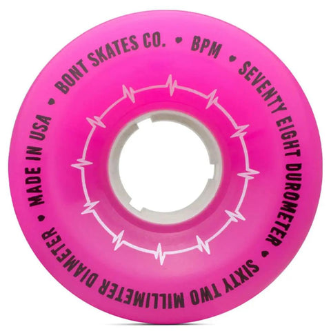 Close-up of hot pink Beats Per Minute Quad Roller Skate Wheel 62x35mm 78A, labeled and made in USA, for outdoor use.