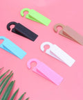 Set Of 6 Thermoplastic Rubber Door Stopper Wedges For Anti Slip Protection And Finger Pinch Prevention, colorful on pink surface