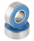 Close-up of 25 Pack Small Sealed Ball Bearings MR115 2RS 5x11x4mm Steel With Rubber Seals in a stack, blue seal detail