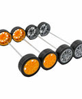 Close-up of assembled Twenty Piece Toy Wheel Set With 2mm Shaft Holes For DIY RC Cars, featuring orange and silver rubber tire wheels.