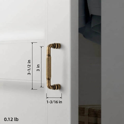 Antique Brass Fluted Cabinet Pulls, 3 Inch Hole Centers, attached to a white cabinet, showing size dimensions