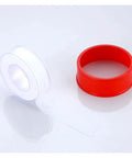 Premium Raw Thread Sealing White Teflon Tape With Pure Oil Free Formula For Tight Fitting Pipe Connections Extra long 50 Meters, displayed on a surface next to a red dispenser.