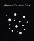 White zirconium oxide ceramic bearing balls in varying sizes scattered on a black background.