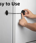 Person using No Keys Needed Fridge And Freezer Child Safety Lock With Ultra Strong Adhesive on a fridge door, black color.
