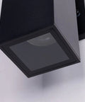 Close-up of Outdoor Porch Light 2 Pack Dusk to Dawn Photocell Sensor Wall Sconces, matte black rectangular tube with tempered glass cover.