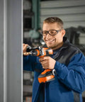 Tough As Nails 18 Volt Cordless 4 Speed Drill Driver With Brushless Motor used by a technician in a workspace setting.
