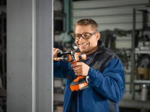 Tough As Nails 18 Volt Cordless 4 Speed Drill Driver With Brushless Motor used by a technician in a workspace setting.