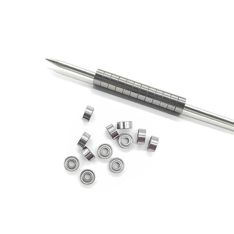 10 Pack Deep Groove Ball Bearings 9x17x5mm For Bicycle And Scooter next to a metal rod, displaying smooth spin and high hardness steel.