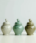 Top Tier Ceramic Airtight Tea Canisters For Loose Tea Leaves And Coffee Beans Hand Embossed Celadon Kirin Design in three colors.