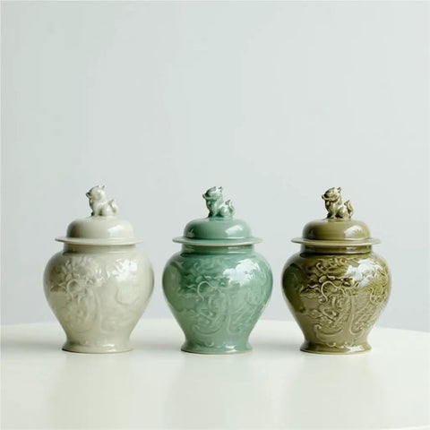 Top Tier Ceramic Airtight Tea Canisters For Loose Tea Leaves And Coffee Beans Hand Embossed Celadon Kirin Design in three colors.