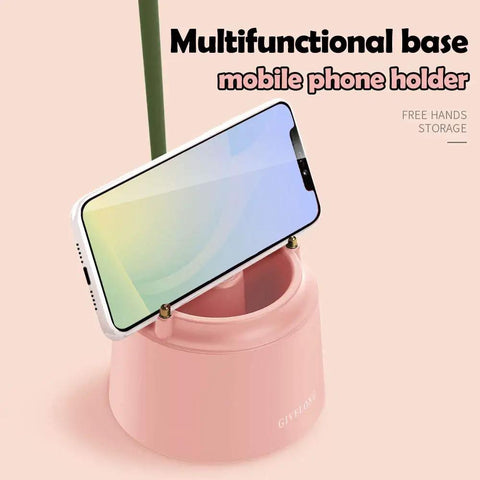 Pink Desk Lamp With Rechargeable LED And USB Charging, Three Color Modes And Stepless Dimming; phone holder base with smartphone.