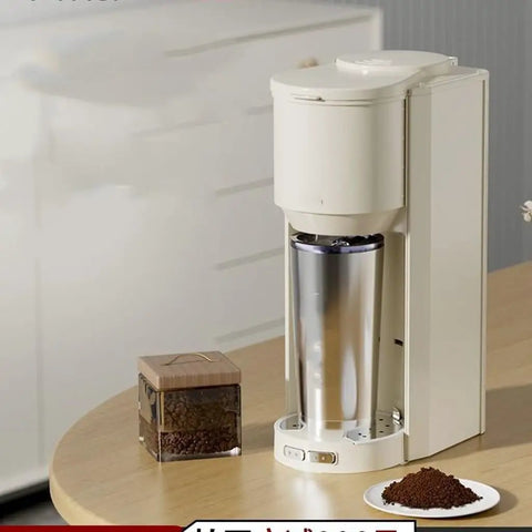 Automatic Coffee Maker With Built In Grinder And Insulated Travel Cup on table with ground coffee