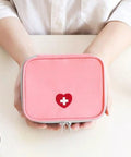 Pink Mini Outdoor First Aid Kit Bag For Travel And Everyday Use, Portable Medicine Organizer With Handy Pockets in hands