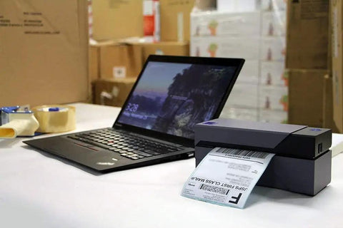 No Sweat Usb Shipping Label Printer Commercial Grade 4x6 Thermal printing a shipping label beside a laptop in a warehouse.