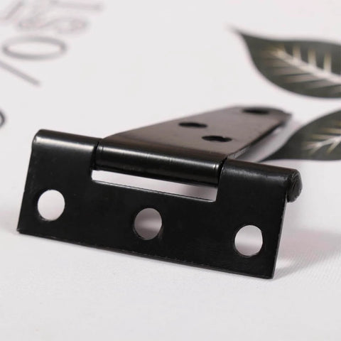 Close-up of black hinge resembling 2 Pcs Galvanized T Shaped Gate Hinges, Rust Resistant, 2 Inch Heavy Duty T Strap Hinges for outdoor use.