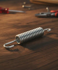 Solid Build 3-5/8 Stainless Steel Recliner Mechanism Tension Spring With Long Neck Hook on workbench with tools.