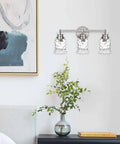 Three Light Vanity Light Over Mirror In Brushed Nickel Finish With Hammered Glass Shade Modern Metal Wall Sconce For Bathroom Hallway Or Makeup Table The Go-To Lighting Fixture mounted on a wall
