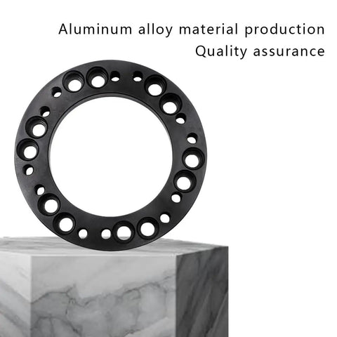 Heavy Duty 12mm Steering Wheel Hub Adapter And Wheel Spacer Blocks Built Tough From Corrosion Free Aluminum Alloy close-up view on cubed marble.