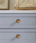 Round Knobs 1 Inch Solid Zinc Alloy Antique Brass Cabinet Handles on grey drawers, 4 pack, vintage kitchen bath drawer pulls.