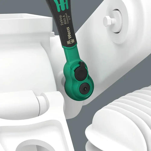 Slim 1/4 Inch Drive Ratchet with Reversible Lever in tight space, ergonomic soft grip visible, 80-tooth gear mechanism.