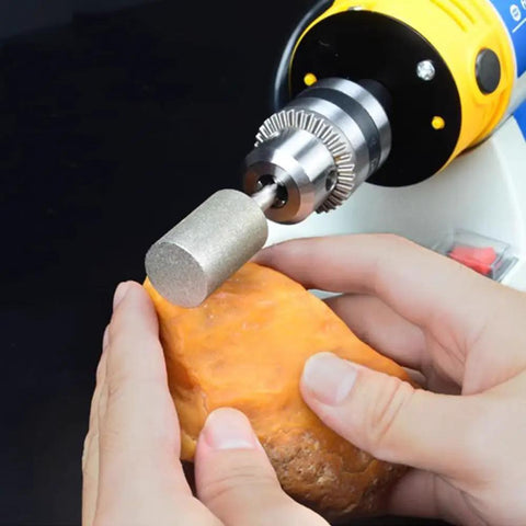 Pro Grade 14mm Diamond Grinding Bits Cylinder Head One Quarter Inch Shank 120 Grit Diamond Coated Burr mounted on a tool grinding stone.