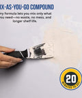 Hand using trowel to apply compound from All In One Drywall Repair Kit With Wall Plate, Two Patch Compound Bags, Dual Grit Sanding Block.