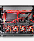 Front view of a black computer tower with red liquid-cooling tubes and four illuminated fans