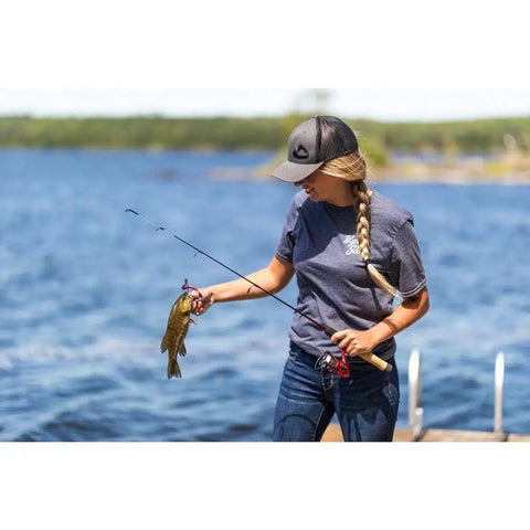 Dock Runner Spinning Reel And Fishing Rod Combo 36 Inch Medium Action used by angler holding fish by water