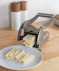 French fry cutter, stainless steel handheld potato slicer with dual blades on a kitchen counter