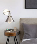 Heavy Duty Adjustable Wall Sconce With Sleek Up Down Shade And E27 Socket for bedroom reading lights beside a cozy bed.