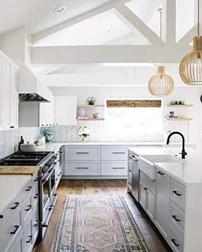 Modern kitchen featuring Grace Collection Riverside Pull Five And One Sixteenth Inch Flat Black Cabinet Hardware Bar Handle on white cabinets.