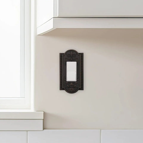 Meadows Light Switch Cover Plate In Greek Revival Style With Decorative Border And Curved Edges, installed in a chic kitchen.
