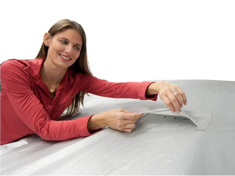 Woman adjusting Heavy Duty All Weather Car Cover Gonna Shield Your Tesla Model S Like Armor While Crushing Rain Snow And UV Damage