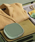 Pretty Slick Portable Mini Washing Machine Compact Folding Washer For Socks Underwear And Baby Clothes Super Lightweight Travel Laundry Gadget shown in a suitcase with folded clothes.