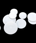 Set Of 10 White PTFE Round Discs, 40mm Diameter, 2mm Thick, Flat Sealing And Insulating Discs arranged on a black background