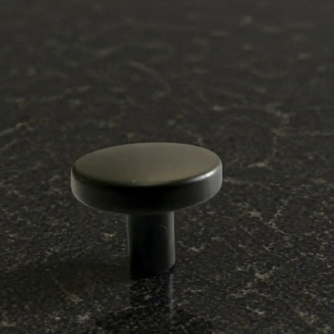 Single knob from Matte Black Round Cabinet Knobs 2 Pack With Screws showcasing smooth edges on dark surface.