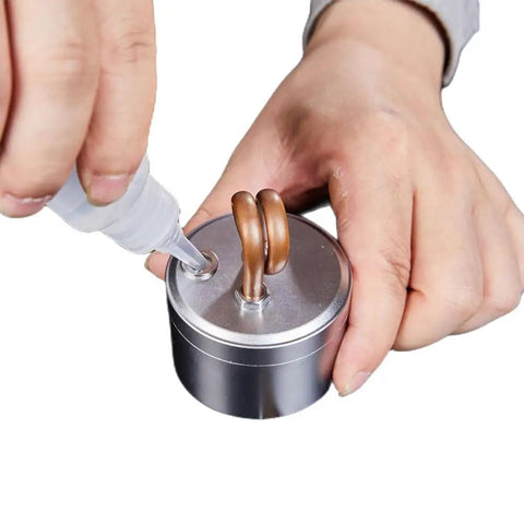 Person filling Ultra Lite Alcohol Camping Stove With Stand Tiny But Mighty 50ml Denatured Alcohol Burner for Hiking