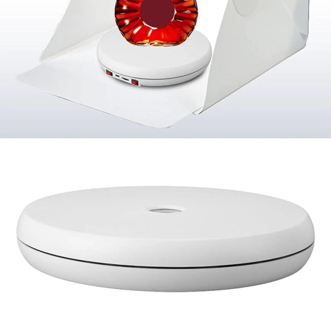 Stunning 25 Cm Electric Rotating Display Stand With Led Light showcasing white acrylic base with USB ports and placed under backdrop.
