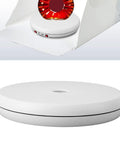 Ymiko Motorized 360 Rotating Display Stand With Built In Led Light, sleek white electric turntable for showcasing products.