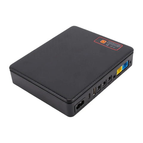 Keep Your Internet Lit With This Reliable 12000mAh Mini UPS Battery Backup That Gives Your Router And Modem Plenty Of Juice For Seven Hours Of Smooth Streaming And Zero Dead Zones On US Plug, showing low-profile black mini UPS.