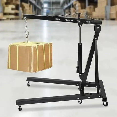 Heavy Duty 2 Ton Folding Engine Lift Hydraulic Cherry Picker Shop Crane with a package suspended above a black steel frame.