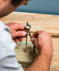 Job Site Ready Rock Solid Precision Pencil Compass With Snap Lock Spring Tension and Nine Inch Layout Span on a workbench.